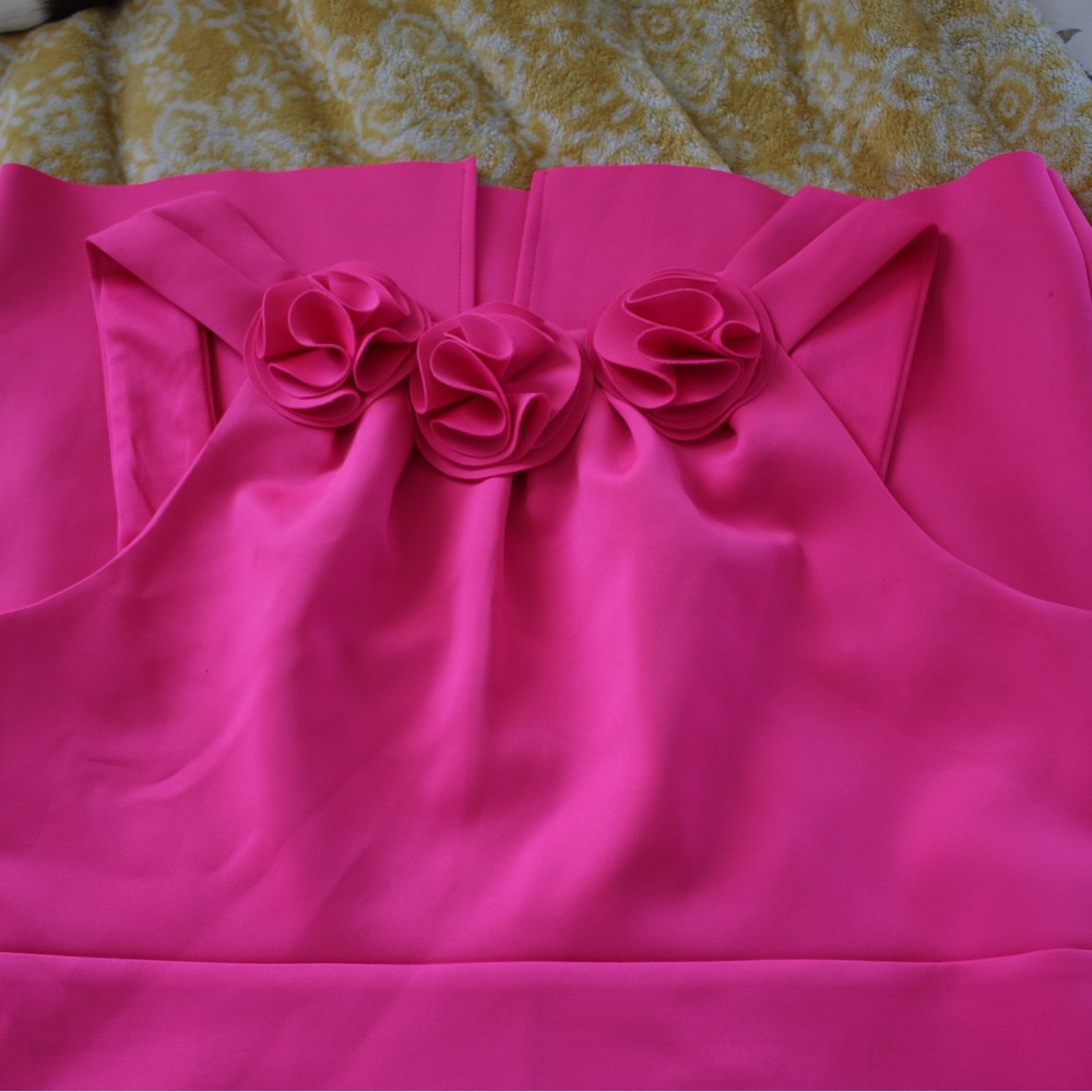 Formal cocktail dress with 3 floral appliqués in front.